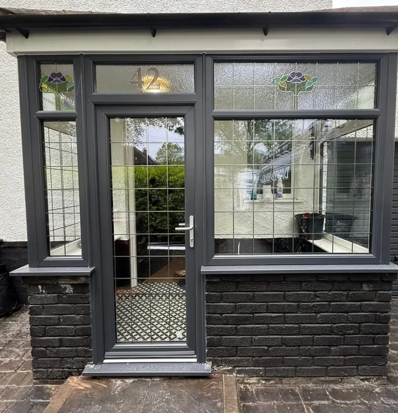 Porch with dark framed glazing and a glazed front door